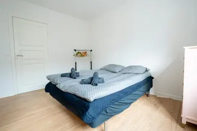 a bedroom with a bed with blue teddy bears on it at Modernized Bed & Bath in Holstebro
