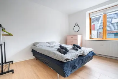 a bedroom with a bed in a room with a window at Modernized Bed & Bath in Holstebro