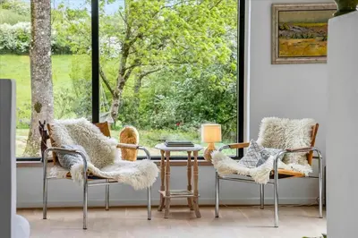 a room with two chairs and a table and a window at Summer House Close To Nature By The Limfjord in Nykøbing Mors