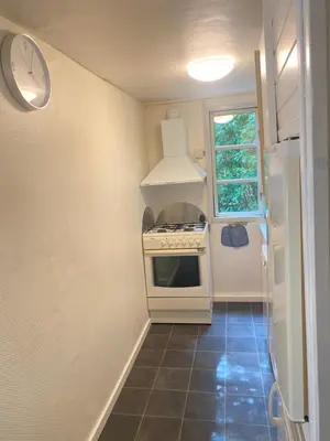 a small kitchen with a stove and a window at Ålevænget 1 in Gedsted