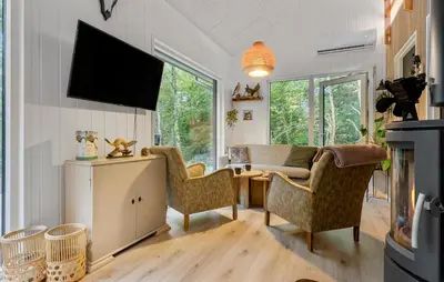 a living room with a tv and a couch and chairs at Amazing Home In Aars With Wifi in Års