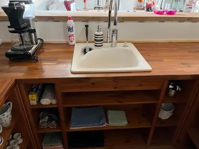 a sink in a wooden counter in a kitchen at Stor lejlighed i landlige omgivelser in Bækmarksbro