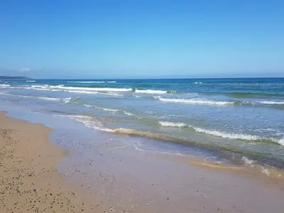 a beach with the ocean and the shoreline at 6 person holiday home in Brovst-By Traum in Brovst