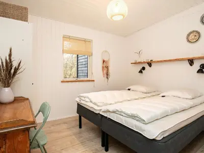 a bedroom with a large bed in a room at 10 person holiday home in Vinderup-By Traum in Vinderup
