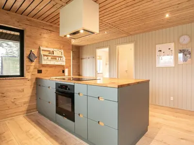 a kitchen with blue cabinets and a stove at 10 person holiday home in Vinderup-By Traum in Vinderup
