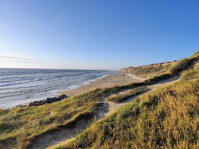 a sandy beach with the ocean in the background at 6 person holiday home in Løkken-By Traum in Løkken