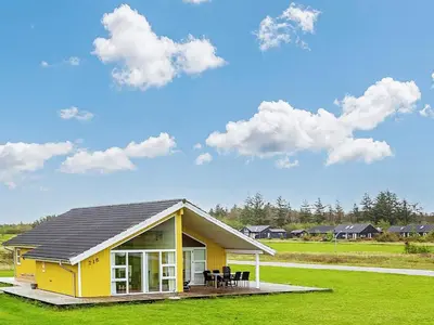 a yellow house with a roof on a green field at 10 person holiday home in Brovst-By Traum in Brovst