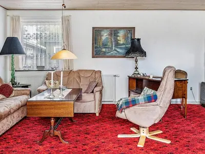 a living room with a couch and a chair at 4 person holiday home in Bøvlingbjerg in Bøvlingbjerg