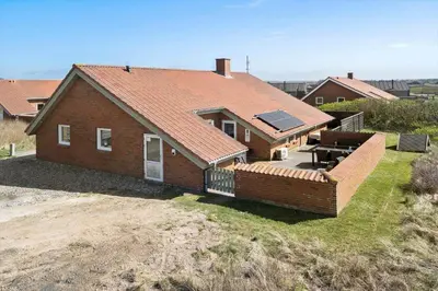 a house with a roof on top of a field at 288-Harboore-Doblervej-15 in Harboør