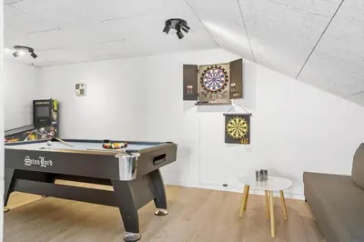 a ping pong table in a living room with a pool table at 288-Harboore-Doblervej-15 in Harboør