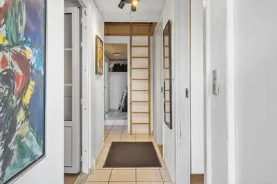a hallway with white walls and a rug on the floor at 288-Harboore-Doblervej-15 in Harboør