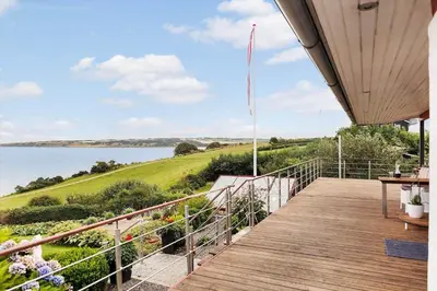 a wooden deck with a view of the water at G295-Lemvig-Syrenvej-95 in Lemvig