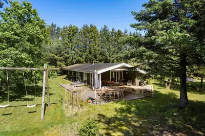 a house with a porch and a swing at LK1123-Lokken-Piasvej-16 in Løkken