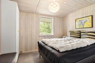 a bedroom with a large bed and a window at LK1123-Lokken-Piasvej-16 in Løkken