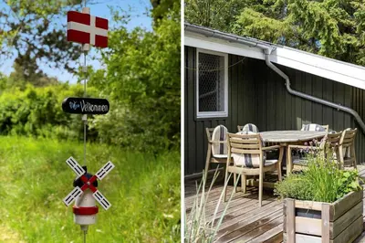 a house with a red cross sign and a table on a deck at LK1123-Lokken-Piasvej-16 in Løkken