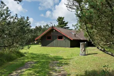 a green building with a red roof in a field at LK473-Lokken-Kettrup-Bjerge-Vej-47 in Løkken