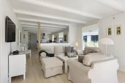 a white living room with couches and a table at LK1706-Lokken-Redningsstien-20-A in Løkken