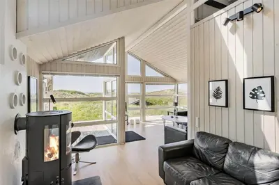 a living room with a couch and a fireplace at LK1001-Lokken-Nellysvej-21 in Løkken