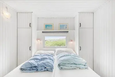 a bedroom with two beds and a window at LK1456-Lokken-Magdavej-9 in Løkken
