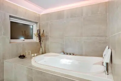 a large white tub in a bathroom with a window at LK1924-Lokken-Lydiavej-4 in Løkken