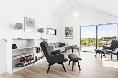 a white living room with a couch and chairs at LK1240-Lokken-Rosavej-13 in Løkken