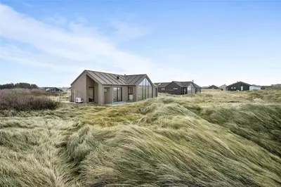 a house in a field with tall grass at LK1240-Lokken-Rosavej-13 in Løkken