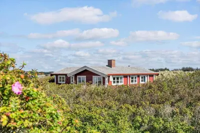 a red house in the middle of a field at LK1427-Lokken-Nannasvej-26 in Løkken