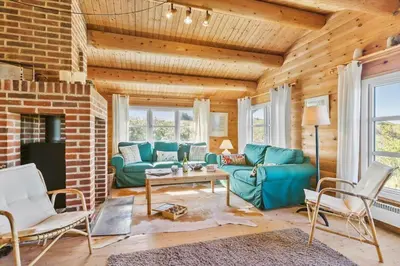 a living room with a blue couch and chairs at LK1427-Lokken-Nannasvej-26 in Løkken