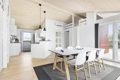 a kitchen and dining room with a table and chairs at LK1423-Lokken-Rikkesvej-4 in Løkken