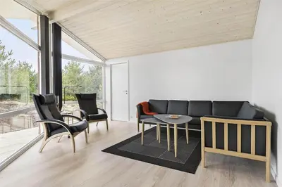 a living room with a couch and chairs and a table at LK1423-Lokken-Rikkesvej-4 in Løkken