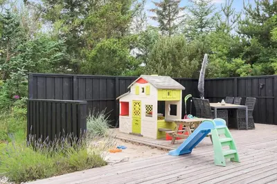 a play house and a slide on a deck at LK2087-Lokken-Karinavej-54 in Løkken