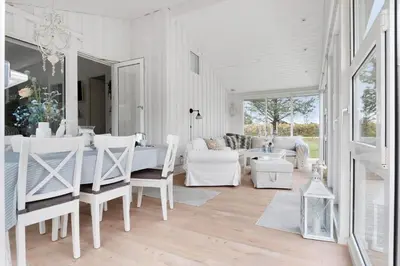 a living room with white furniture and a table at LK2087-Lokken-Karinavej-54 in Løkken