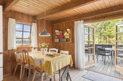 a dining room with a table and chairs at LK2098-Lokken-Magdalenevej-51 in Løkken