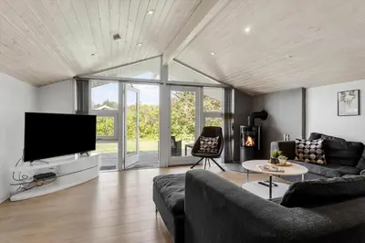 a living room with a couch and a flat screen tv at LK1892-Lokken-Marthinesvej-37 in Løkken