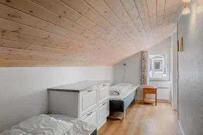 a bedroom with two beds and a desk in it at LK781-Lokken-Margrethevej-6 in Løkken