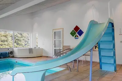 a slide in a house with a swimming pool at LK781-Lokken-Margrethevej-6 in Løkken