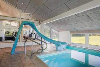 a swimming pool with a slide in a house at LK781-Lokken-Margrethevej-6 in Løkken