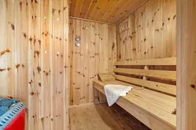 a wooden sauna with a towel sitting in it at LK539-Lokken-Sylviavej-27 in Løkken