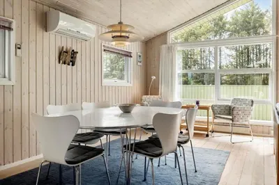 a dining room with a white table and chairs at LK539-Lokken-Sylviavej-27 in Løkken