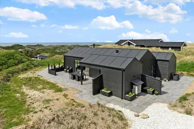 an aerial view of a black house on a beach at LK1824-Lokken-Marthasvej-16 in Løkken
