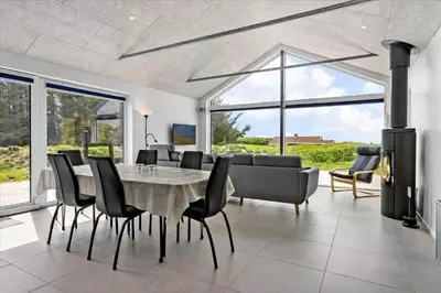 a dining room with a table and chairs at LK1824-Lokken-Marthasvej-16 in Løkken