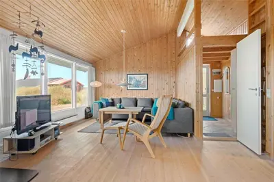 a living room with a couch and a table at LK1054-Lokken-Lottesvej-22 in Løkken