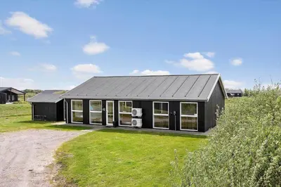 a black house with a black roof at LK1979-Lokken-Kringelbaekvej-42 in Løkken