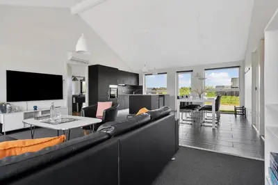 a living room with a couch and a table at LK1979-Lokken-Kringelbaekvej-42 in Løkken