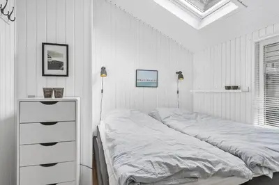 a white bedroom with a bed and a white dresser at LK1999-Lokken-Magdalenevej-35 in Løkken