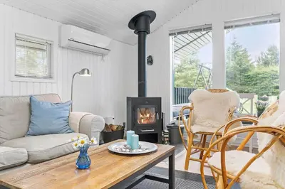 a living room with a couch and a fireplace at LK1999-Lokken-Magdalenevej-35 in Løkken