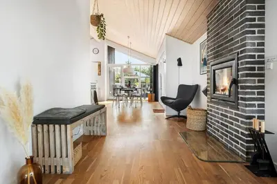 a living room with a couch and a fireplace at LK2095-Lokken-Mievej-28 in Løkken