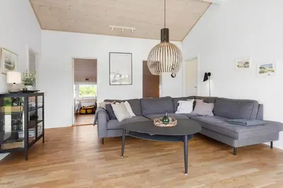 a living room with a couch and a table at LK2095-Lokken-Mievej-28 in Løkken