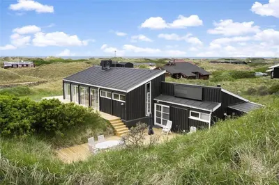 a black house in the middle of a field at LK157-Lokken-Ruthsvej-15 in Løkken
