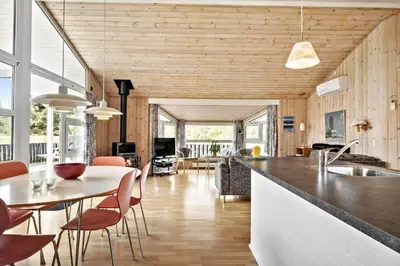 a kitchen and living room with a table and chairs at LK350-Lokken-Piasvej-11 in Løkken